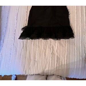 Dennis Basso Silk black mini skirt with hand detailed buttons on the side.